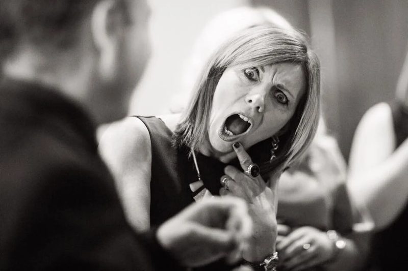 Mark performing close-up magic for a guest at a drinks reception